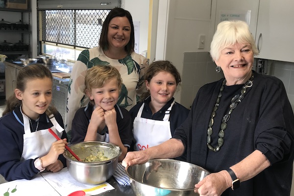 Smiling adults and children in kitchen