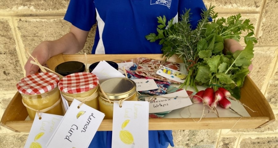 Market items on tray, handstand torso visible behind