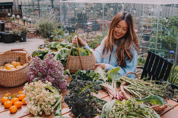 Connie Cao in her backyard with a winter harvest
