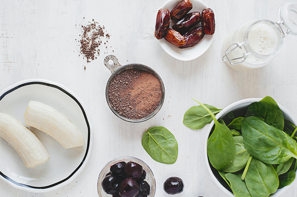 Smoothie ingredients including banana, dates, spinach and blueberries